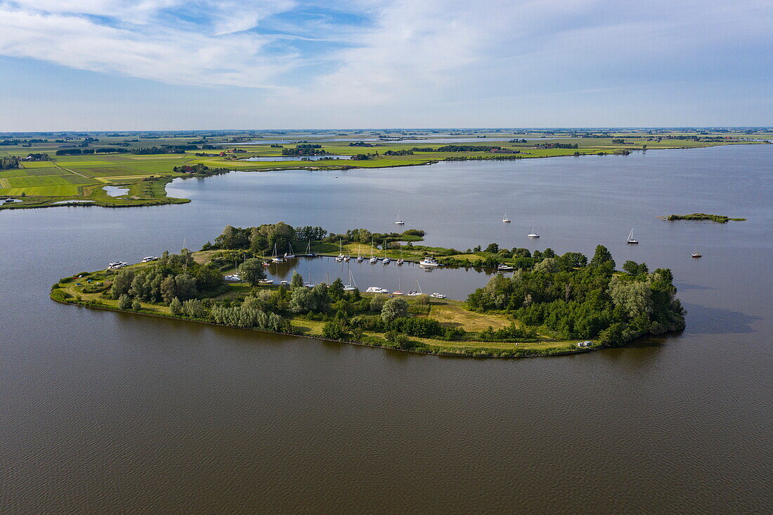 Aerial view of boats moored on the island of Nieuwe Kruispolle in Lake De Fluezen, near It Heidenskip, Friesland, The Netherlands, Europe