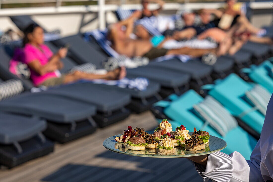 Canapés are served during the Sailaway Party on the Navigator Deck aboard cruise ship Vasco da Gama (Nicko Cruises), Baltic Sea, near Denmark, Europe