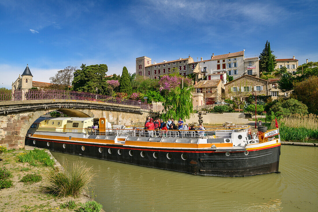 Schiff fährt am Canal du Midi unter Brücke hindurch, Ventenac-en-Minervois, UNESCO Welterbe Canal du Midi, Okzitanien, Frankreich