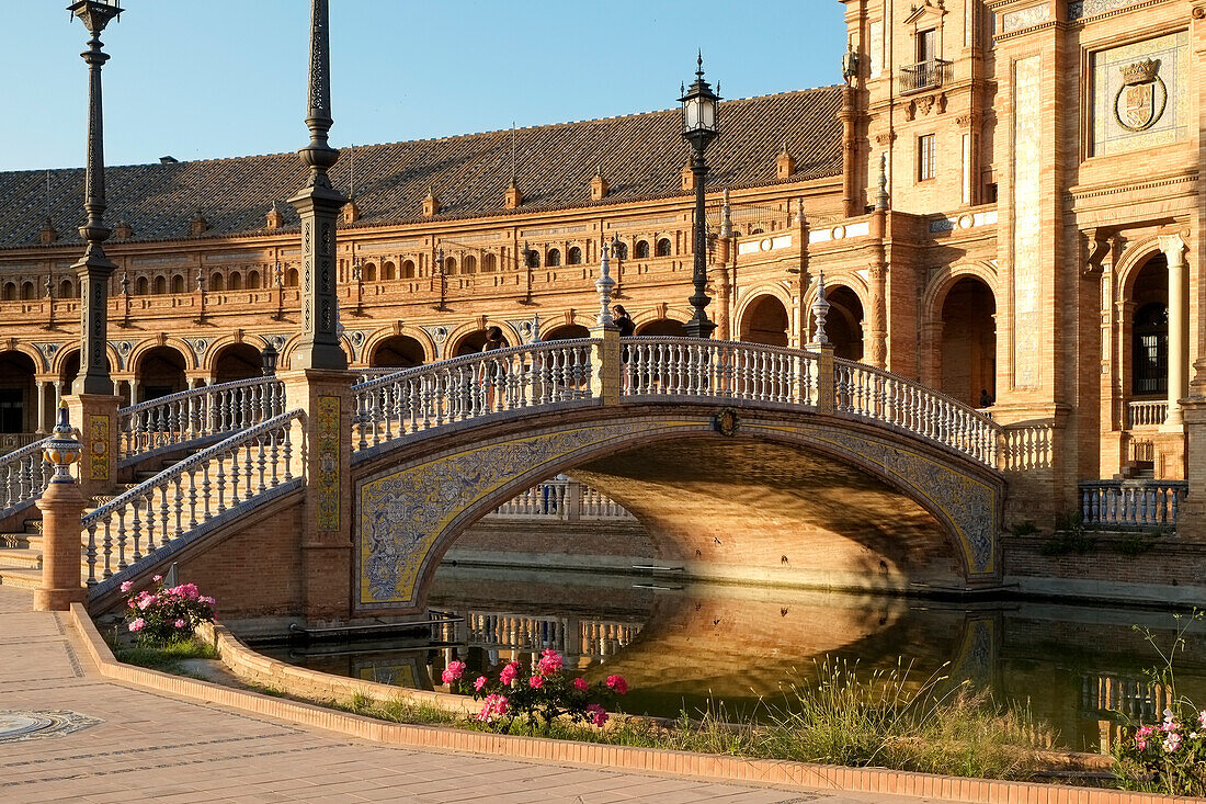 Spain, Seville, Canal reflecting arch bridge at Plaza de Espagna