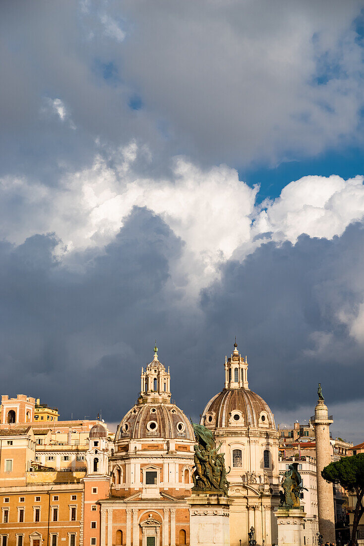 The domes of Rome under a cloudy sky.
