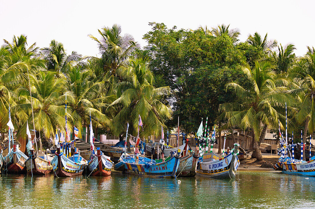 Ada Foah fishing village with painted fishing boats on the banks of the Volta River in the Greater Accra region of eastern Ghana in West Africa