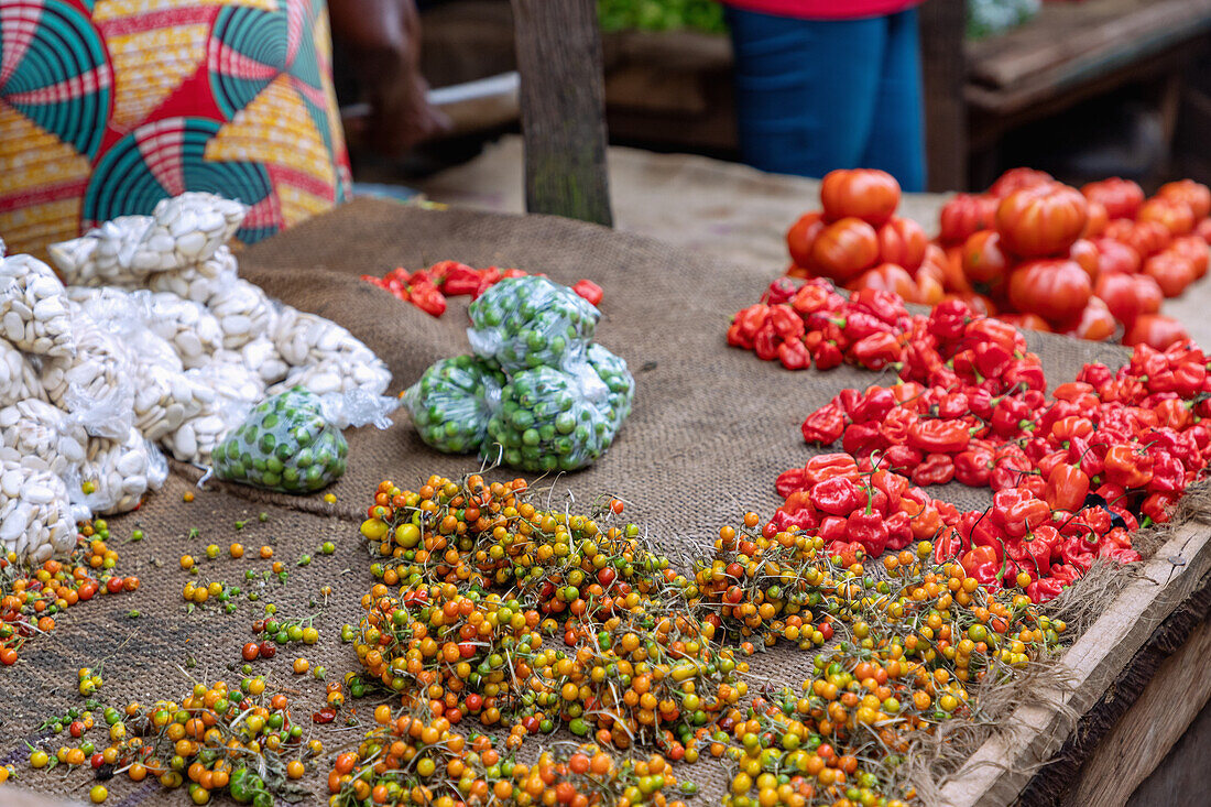 Selling chili, allspice, eggplant peas and tomatoes at the weekly market in Techiman in the Bono East region of central Ghana in West Africa