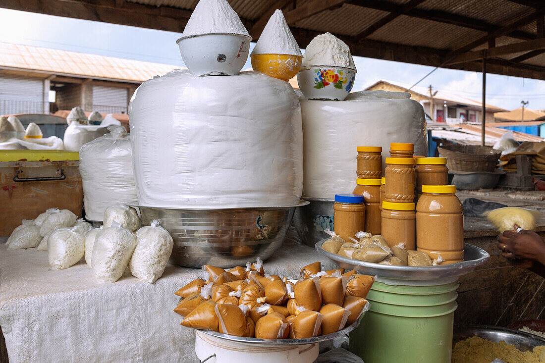 Selling cassava flour, tapioca and peanut butter at the weekly market in Techiman in the Bono East region of central Ghana in West Africa