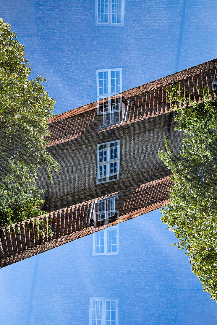 Double exposure of a simple brick building and windows in Copenhagen, Denmark.