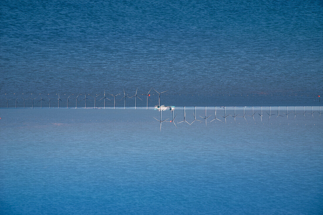 Double exposure of a windfarm on the sea in Copenhagen, Denmark.