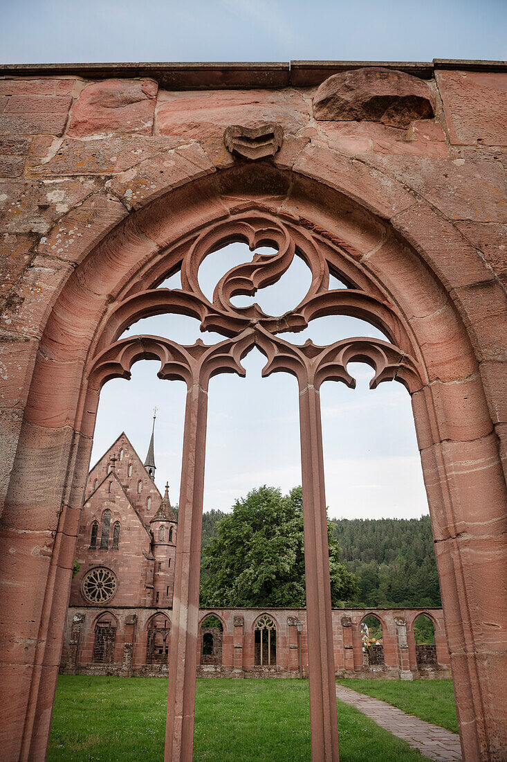 View through the Gothic window of the cloister to the Marienkapelle in Hirsau Monastery near Calw, Baden-Württemberg, Germany, Europe