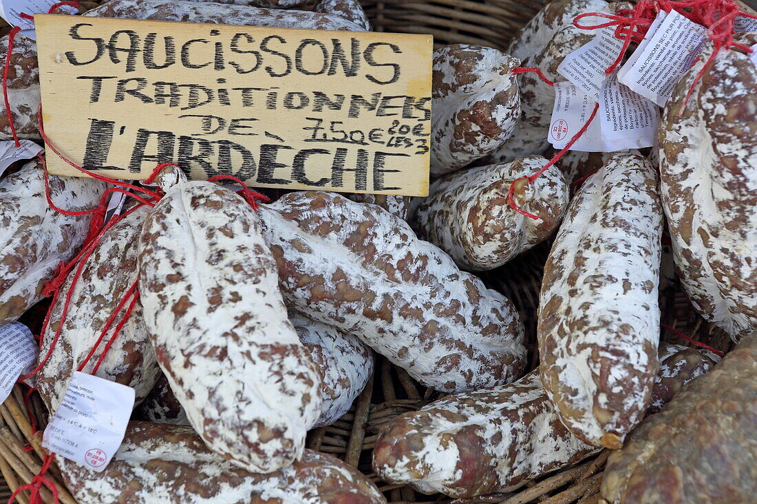 Display with salamis at the Saturday market in Pernes-les-Fontaines, Vaucluse, Provence-Alpes-Côte d'Azur, France