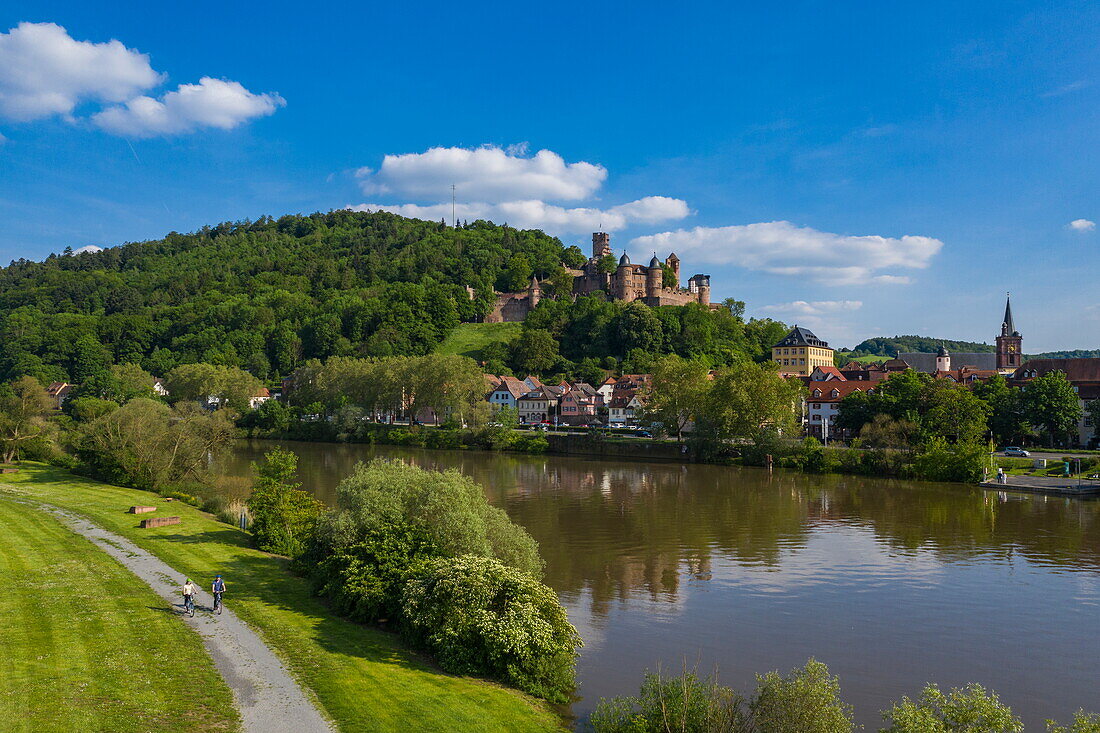 Aerial view of a couple on e-bike bicycles on the banks of the Main with Wertheim Castle in the distance, Kreuzwertheim, Spessart-Mainland, Franconia, Bavaria, Germany, Europe