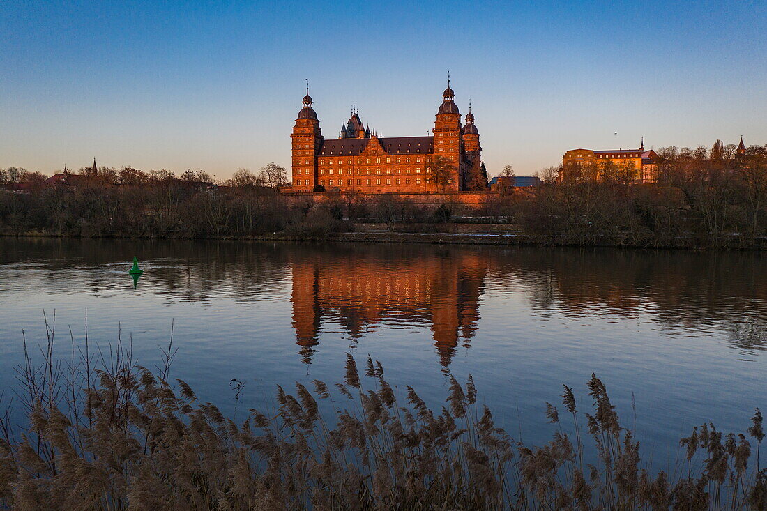Aerial view of Johannisburg Castle reflected in the River Main at sunset, Aschaffenburg, Spessart-Mainland, Franconia, Bavaria, Germany, Europe
