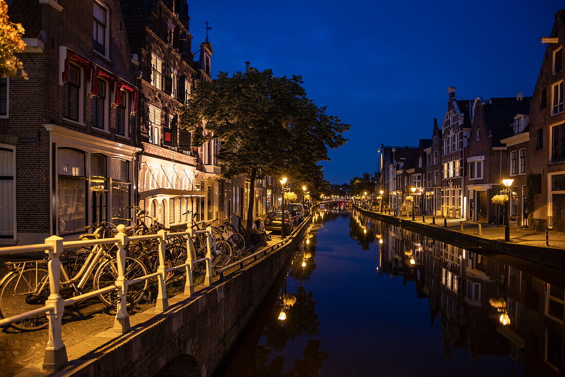 Reflection of buildings in a canal at dusk, Alkmaar, North Holland, The Netherlands, Europe