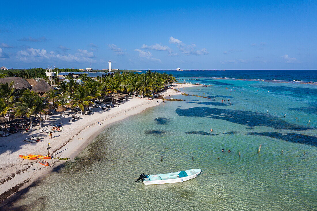 Aerial view of beach and coastline with New Mahahual shopping and entertainment complex with expedition cruise ship World Voyager (nicko cruises) at pier in distance, Mahahual, Costa Maya, Quintana Roo, Mexico, Caribbean