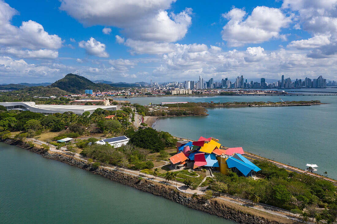 Aerial view of the Biomuseo museum, which focuses on the natural history of Panama and was designed by the renowned architect Frank Gehry, with the city skyline behind, Panama City, Panama, Panama, Central America