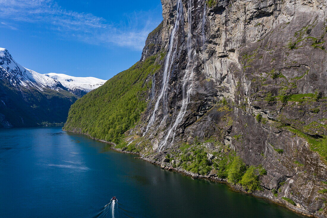 Aerial view of Zodiac inflatable boat excursion from expedition cruise ship World Voyager (nicko cruises) in front of Seven Sisters waterfall in Geirangerfjord, Geiranger, Møre og Romsdal, Norway, Europe