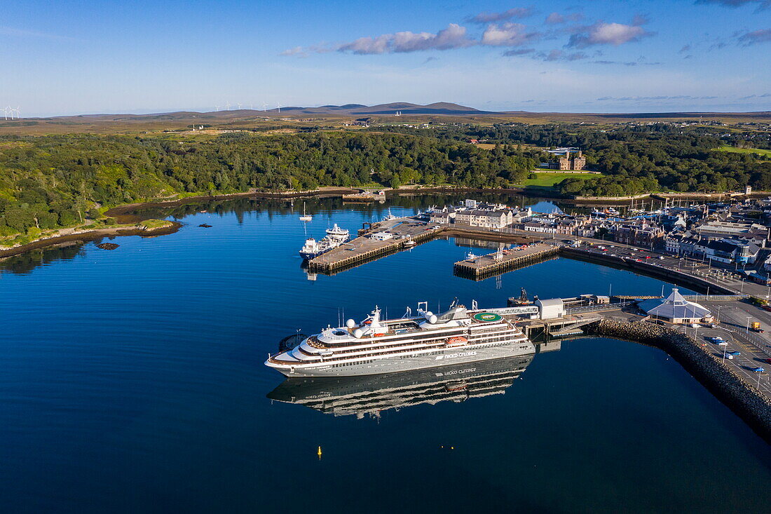 Aerial view of expedition cruise ship World Voyager (nicko cruises) at the pier with town and Lews Castle in the distance, Stornoway, Lewis and Harris, Outer Hebrides, Scotland, United Kingdom, Europe