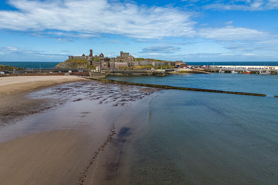 Aerial view of beach at low tide with jetty and Peel Castle in distance, Peel, Isle of Man, British Crown Dependency, Europe