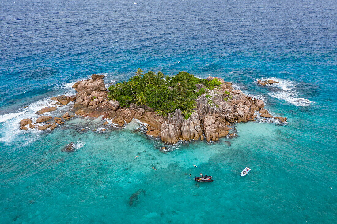 Aerial view of snorkelers in turquoise waters, St Pierre Island, near Praslin Island, Seychelles, Indian Ocean