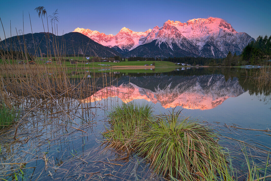 Alpenglow in the Karwendel with a view over the Schmalensee near Mittenwald, Bavaria, Germany.