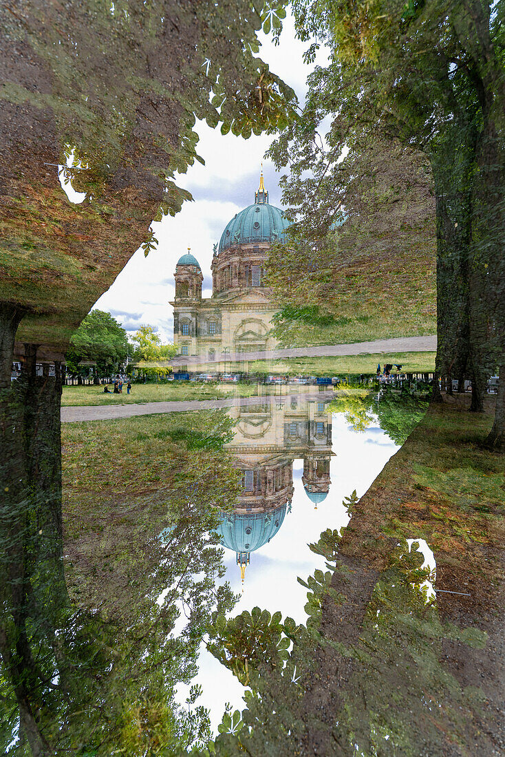 The Dom of Berlin framed by trees.