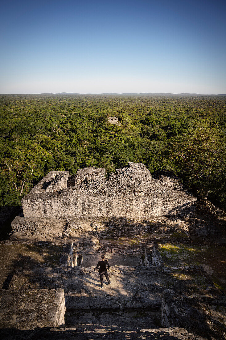 Woman looks at ruined Mayan pyramid temples in the dense jungle of Calakmul, Yucatán, Mexico, North America, Latin America, UNESCO World Heritage