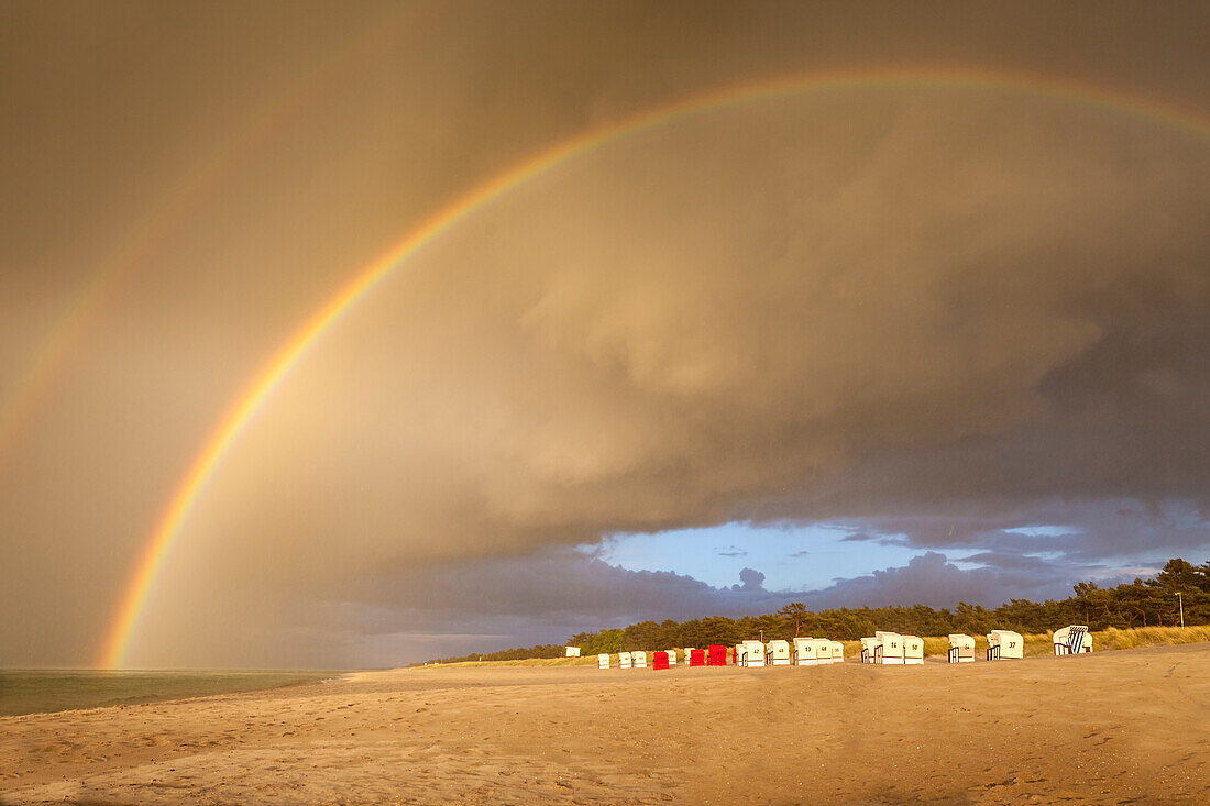 Beach chairs with storm clouds and rainbow in Prerow, Mecklenburg-West Pomerania, Baltic Sea, North Germany, Germany