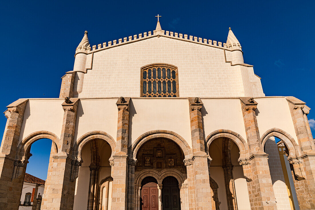 The facade and arches of the Church of Saint Francis in Évora with a blue sky, Portugal.