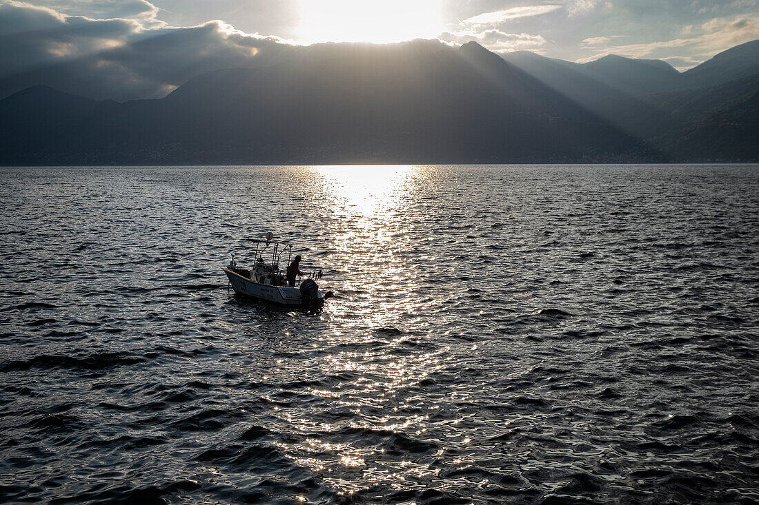 View of a fisherman on Lake Maggiore, Piedmont, Lombardy, Italy, Europe