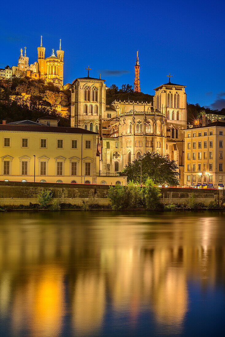 Illuminated Cathédrale Saint-Jean church over the Saone with Basilique Notre-Dame de Fourvière in the background, Lyon, Lyon, Auvergne-Rhône-Alpes, France