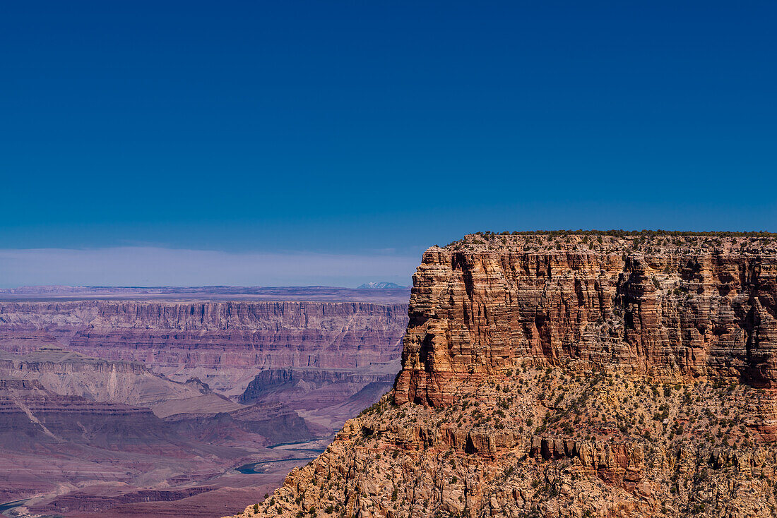 The Grand Canyon as seen from the South Rim in Arizona. The large gorge was eroded over millions of years by weather and the Colorado river that still runs through it. The reddish tint it has is due to the iron contained in the rock's minerals that oxide.