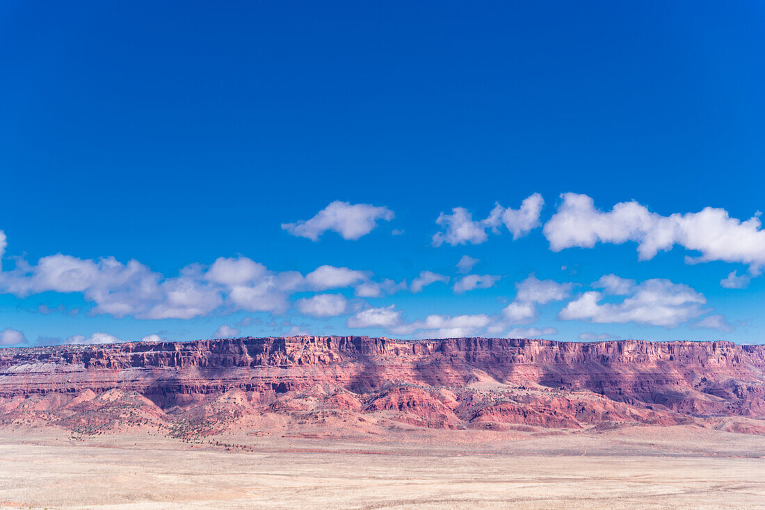 The Vermilion Cliffs National Monument seen on the horizon of the Arizona desert.