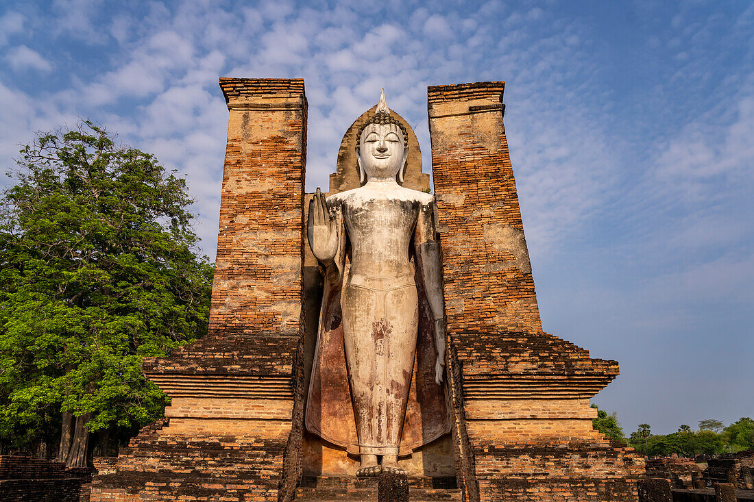 Giant standing Buddha at Wat Mahathat temple in UNESCO World Heritage Sukhothai Historical Park, Thailand, Asia