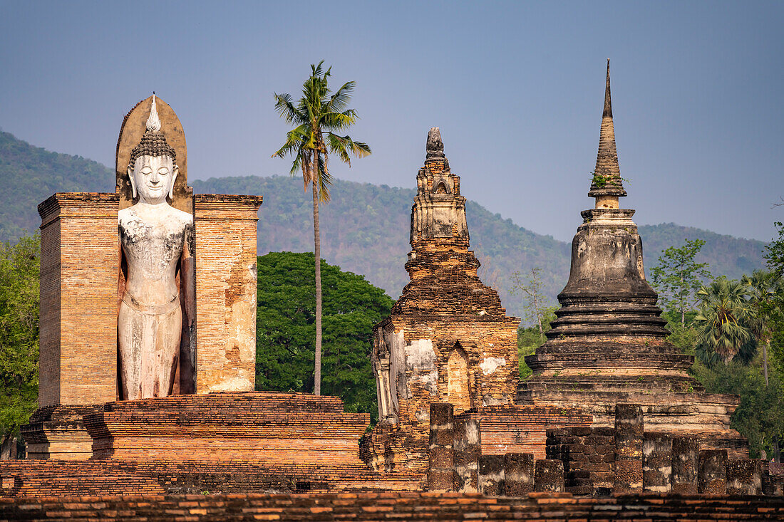 Giant standing Buddha at Wat Mahathat temple in UNESCO World Heritage Sukhothai Historical Park, Thailand, Asia