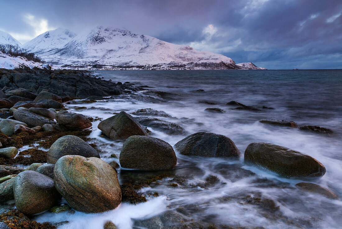 Wintry coastal landscape in the Norwegian Sea near Tromvik, Norway.