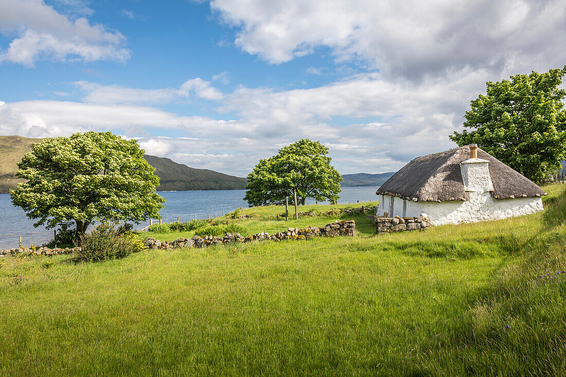 Thatched roof cottage on Loch Airnord near Luib, Isle of Skye , Highlands, Scotland, UK