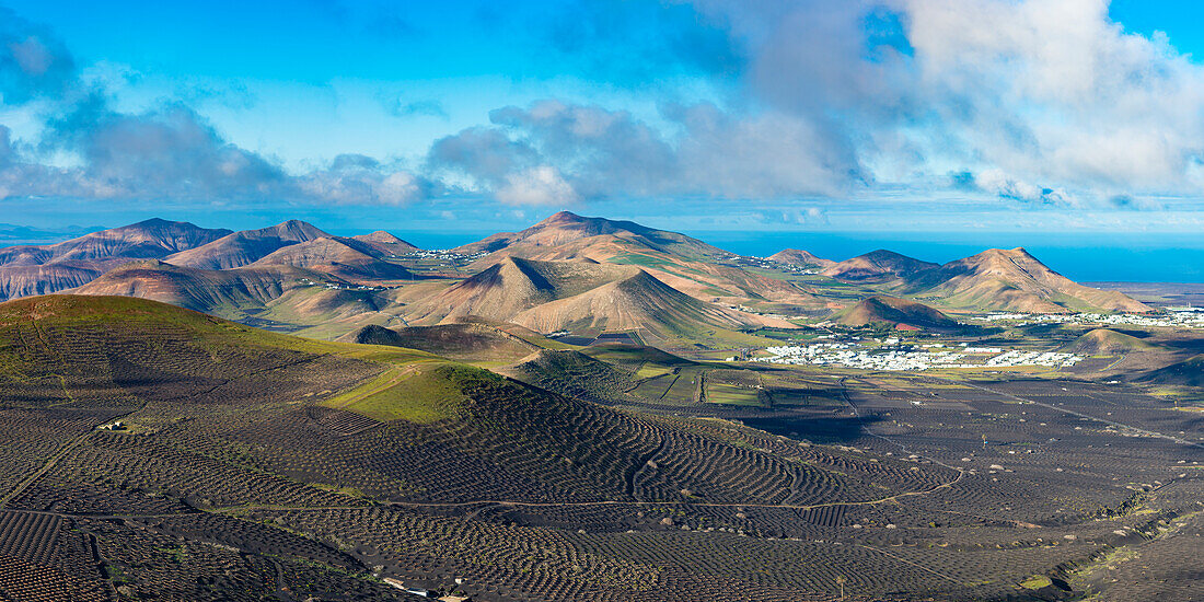 Sunrise panorama from Montana de Guardilama to the La Geria wine region, with the towns of Uga and Yaiza behind, Lanzarote, Canary Islands, Spain, Europe