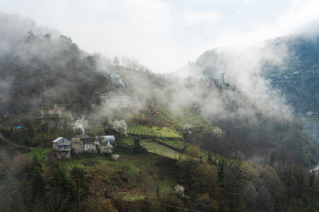 Little village in the Adjarian mountain region of Georgia in misty day