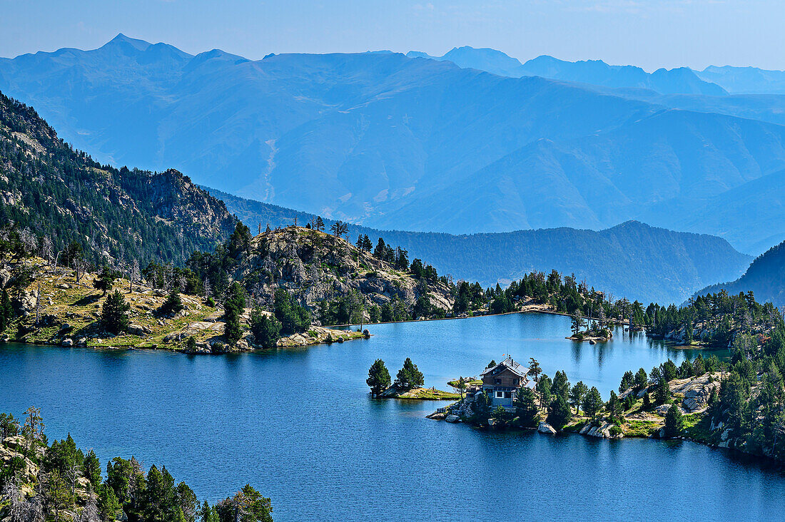 Deep view of mountain lake Estany Trullo with Refugi Josep Maria Blanc hut, Aigüestortes i Estany de Sant Maurici National Park, Catalonia, Pyrenees, Spain