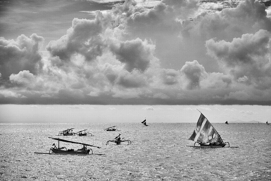 Fishing boats on the water in Seraya, Bali Indonesia against a dramatic afternoon sky.