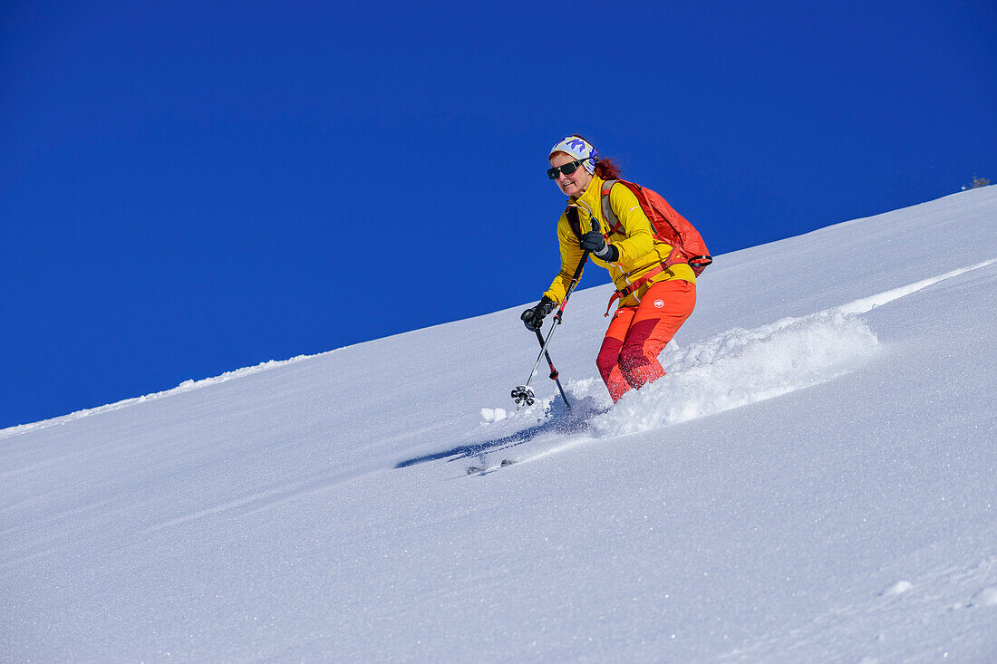 Woman on ski tour descends from Wiedersberger Horn, Wiedersberger Horn, Kitzbühel Alps, Tyrol, Austria