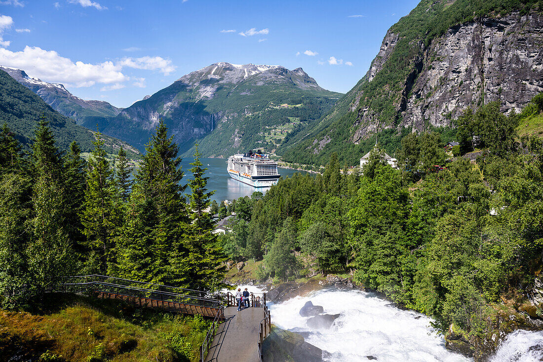 Blick auf den Wasserfallwanderweg und Kreuzfahrtschiff im Geirangerfjord, Geiranger, Moere og Romsdal, Vestlandet, Norwegen