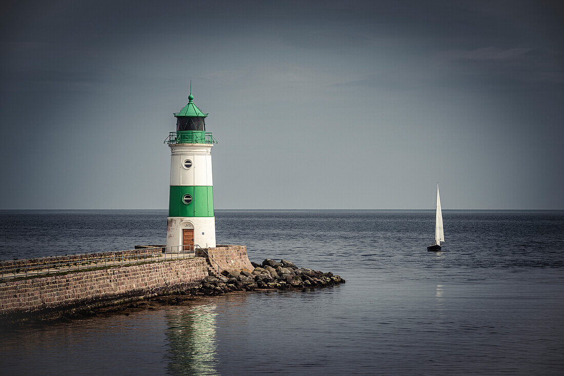 The Schleimuende lighthouse with sailing boat, Schleswig-Holstein, Germany, Europe
