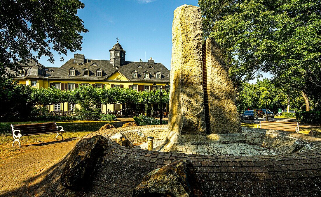 Niederwald hunting lodge with restaurant terrace under plane trees, seen from the fountain in the park, Upper Middle Rhine Valley, Hesse, Germany