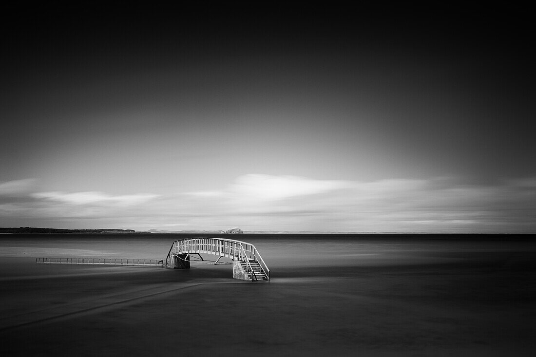 View of a bridge on the beach at high tide, East Lothian, Scotland, UK