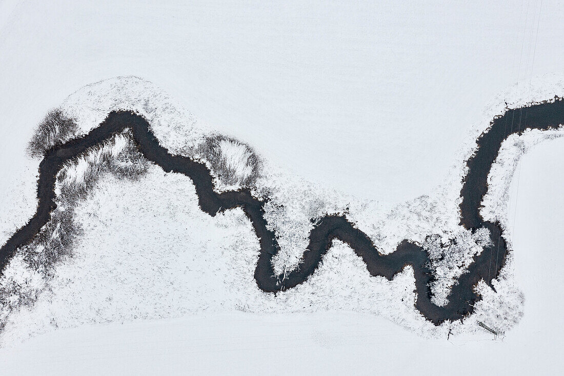 River meanders through snowy landscape, top down view of the Hürbe (river), Swabian Jura, Baden-Wuerttemberg, Germany, Europe