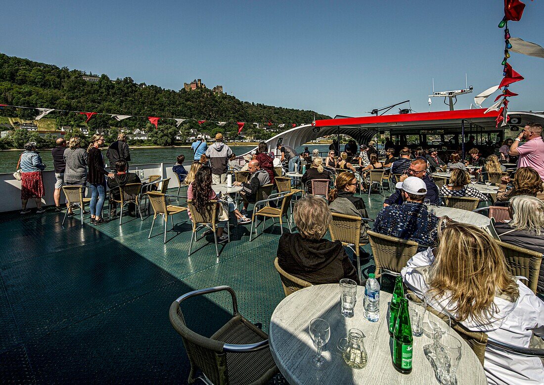 Passengers during a panoramic trip on the Rhine with a view of the Schönburg, Oberwesel, Upper Middle Rhine Valley, Rhineland-Palatinate, Germany