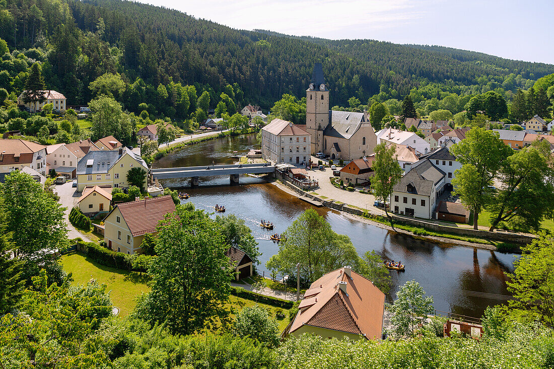 Rožmberk nad Vltavou with the Church of St. Nicholas and rubber boats on the Vltava River in South Bohemia in the Czech Republic