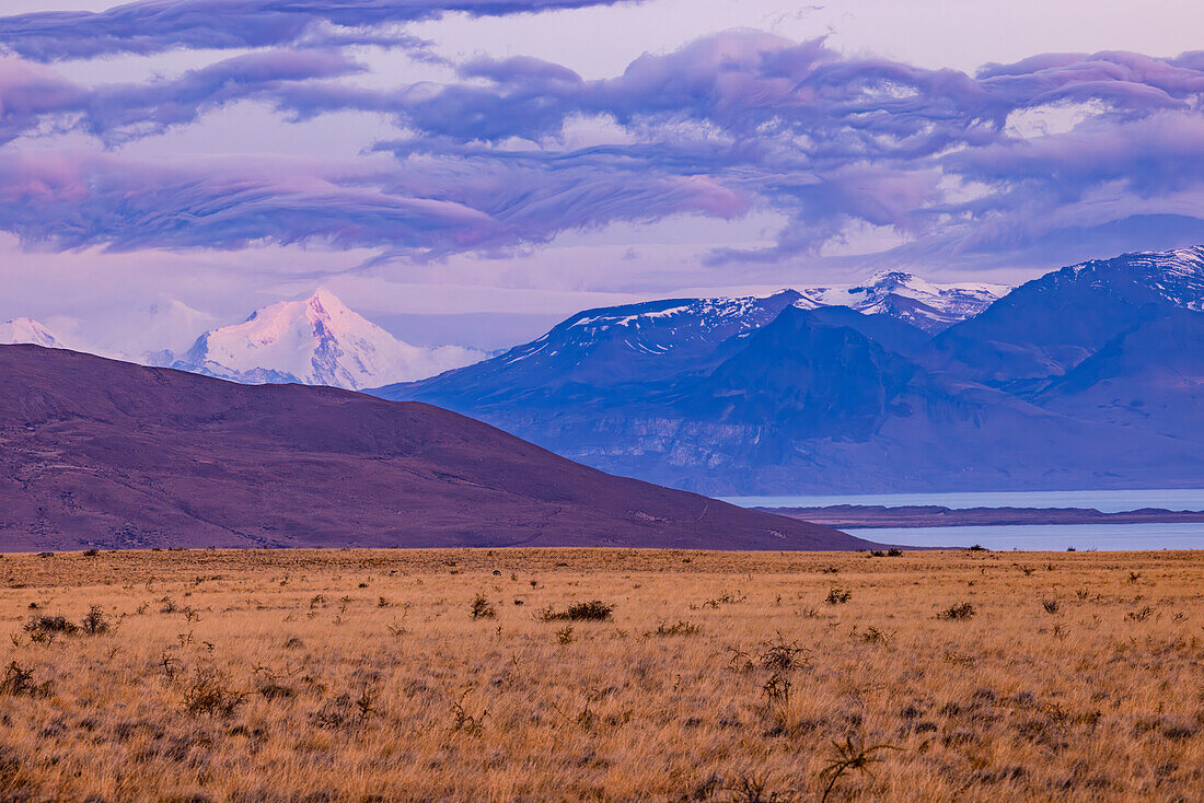 Bizarrely ruffled clouds over the snowy Andes mountains at dawn, Santa Cruz Province, Argentina, Patagonia