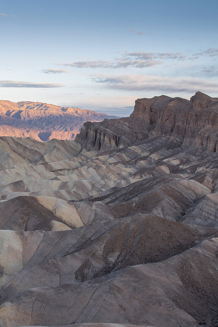 Sunrise with mountain glow. Rock formations in the foreground. Zabriskie Point, Death Valley