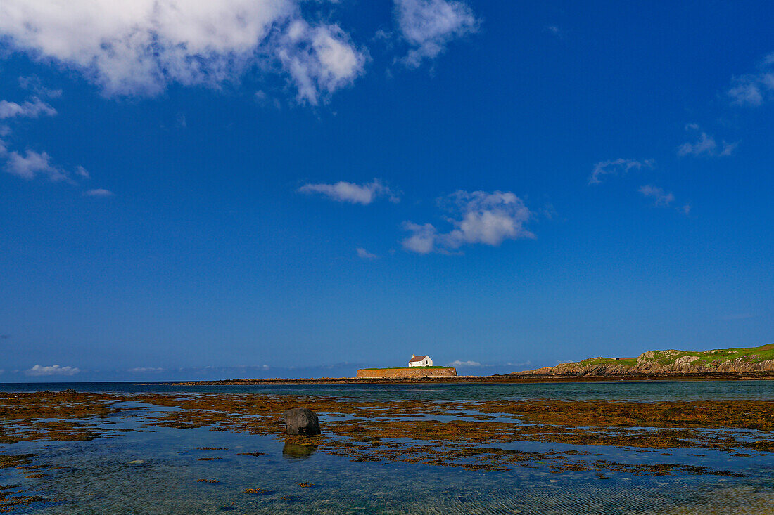 UK, North West Wales, Anglesey Island, Eglwys Cwyfan is a listed medieval church in Llangadwaladr. It is located on the small tidal island of Cribinau and can only be reached at low tide.