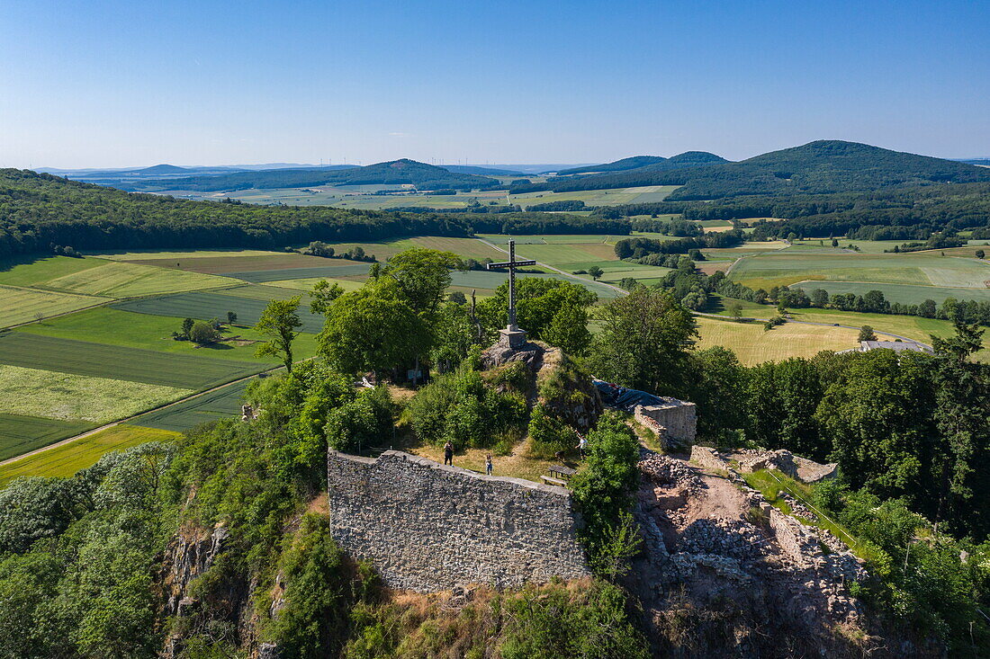 Aerial view of the cross on the Haselstein castle ruins on the Schlossberg in the Hessisches Kegelspiel region, Nüsttal Haselstein, Rhön, Hesse, Germany